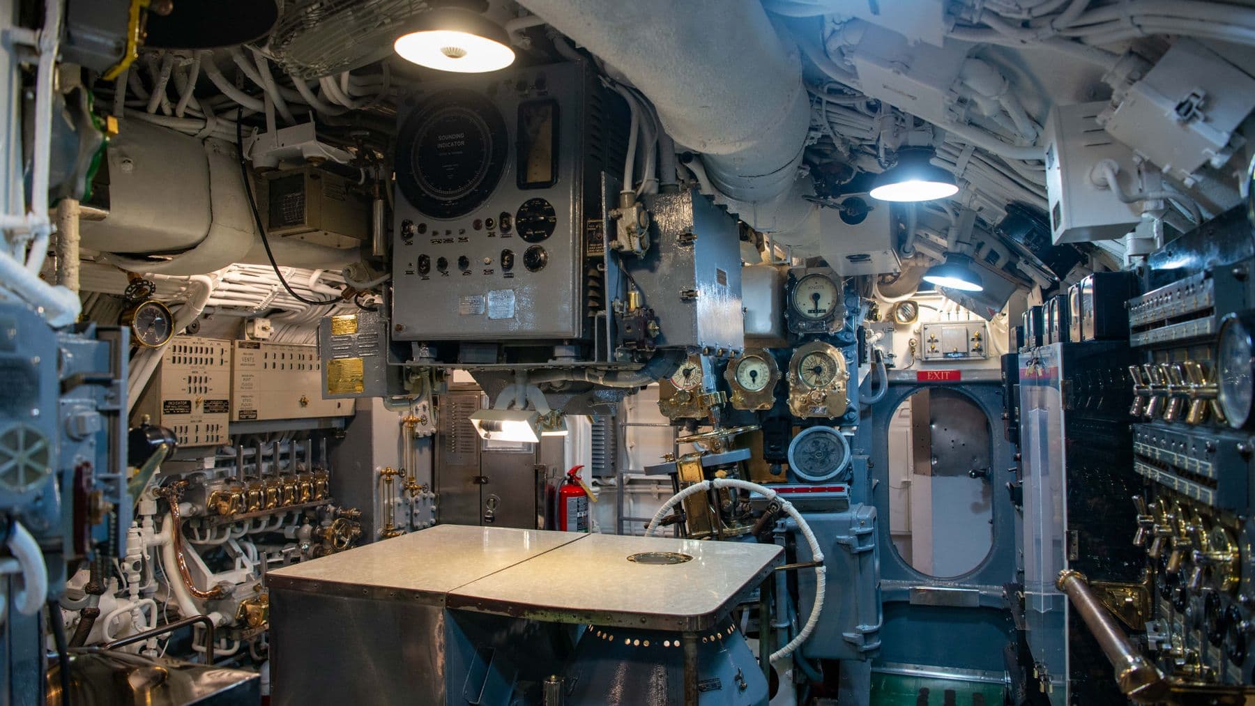 Explore the intricate details of a vintage submarine control room, showcasing complex machinery and gauges.